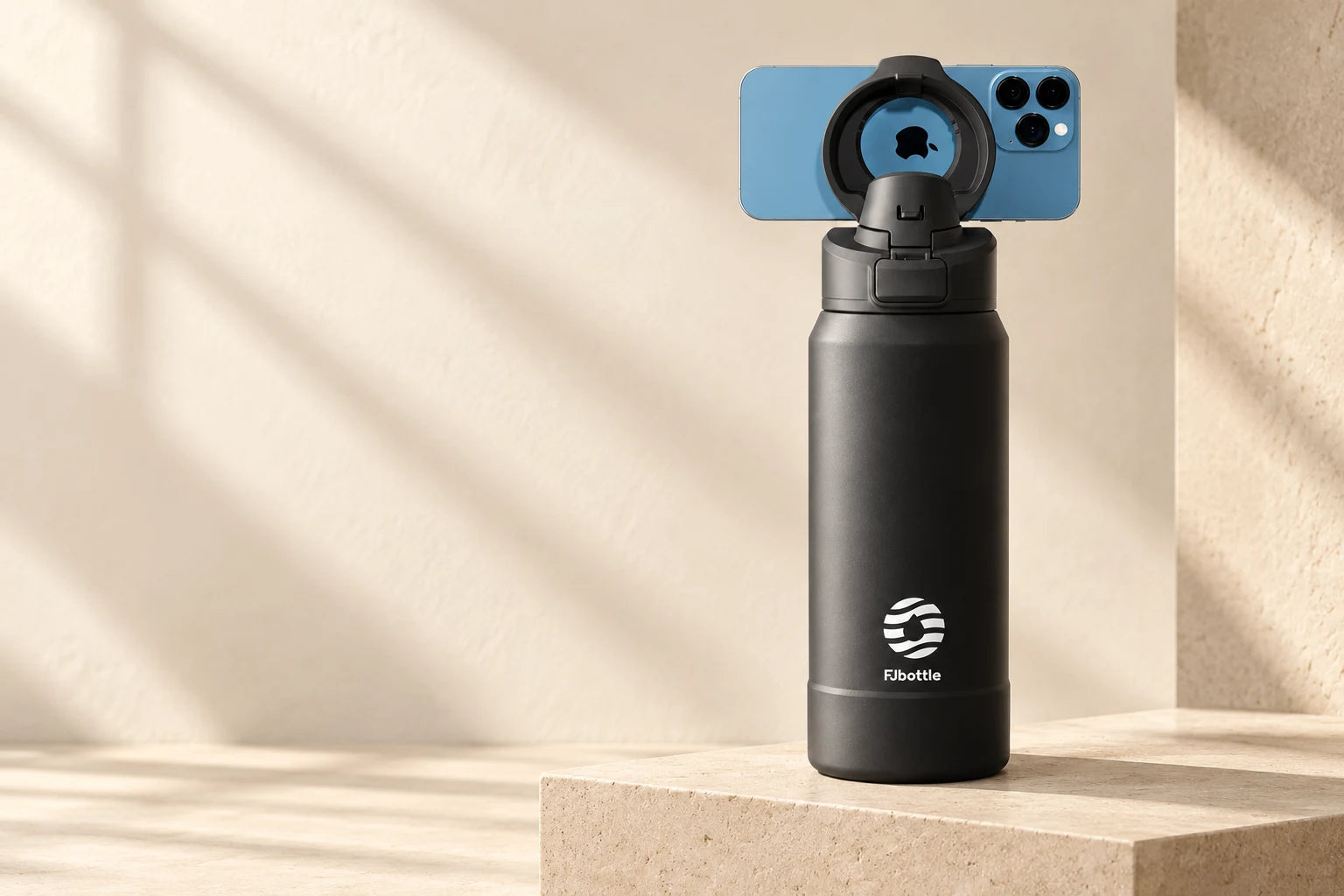 Black stainless steel bottle with a magnetic phone holder and a mounted phone
